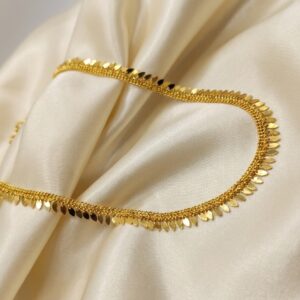 Gold-tone Elakathali leaf necklace on cream fabric – SunShoppers UK