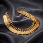 Gold-tone Kasu coin necklace on display bust – SunShoppers UK