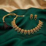 Gold-tone green stone kite motif necklace set with thread closure – SunShoppers UK