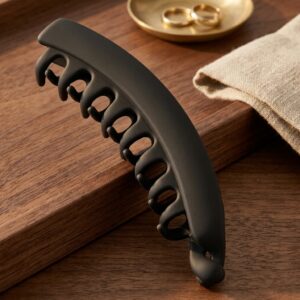 Large matte hair claw clip in black on wooden surface – SunShoppers UK