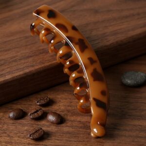 Glossy acetate hair claw clip on marble surface – SunShoppers UK