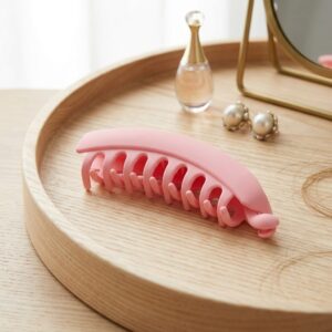 Large matte hair claw clip in pink on wooden surface – SunShoppers UK