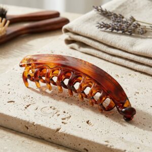 Glossy acetate hair claw clip on marble surface – SunShoppers UK