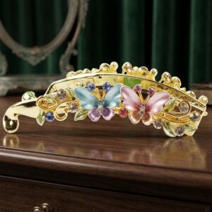 Blue and pink enamel butterfly barrette hair clip on wood surface