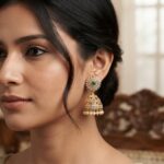 gold-tone sunburst jhumka earrings with AD-style stones and pearl-style drops