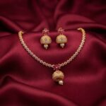 jhumka pendant necklace set with pearl-style drop and matching jhumka earrings