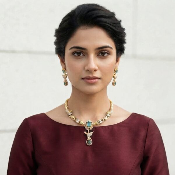 Gold-tone aqua blue necklace set with cubic zirconia, bird motif drop, aqua-coloured stones and matching drop earrings