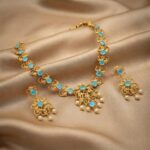 filigree necklace set with pearl-style drops and matching floral earrings
