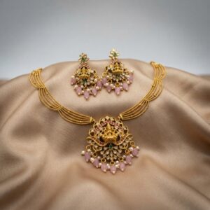 Lakshmi pendant necklace set with layered gold-tone chain and chandelier earrings