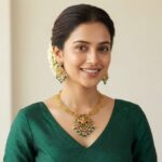 Lakshmi pendant necklace set with layered gold-tone chain and chandelier earrings