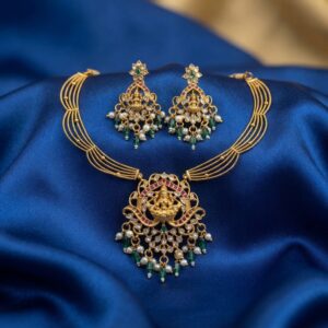 Lakshmi pendant necklace set with layered gold-tone chain and chandelier earrings