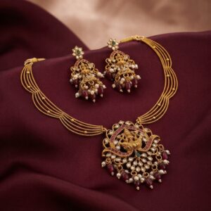 Lakshmi pendant necklace set with layered gold-tone chain and chandelier earrings