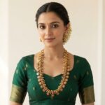 Antique gold-tone Nagas necklace set with Lakshmi motifs, ruby-coloured floral medallions, faux pearl drops and matching stud earrings