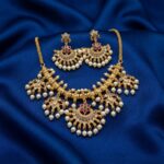 gold-tone necklace set with fan-shaped pearl-style drops and matching chandelier earrings