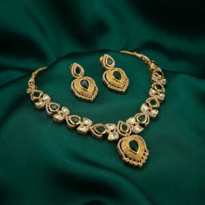 kundan-style teardrop necklace set with engraved gold-tone pendant and matching earrings