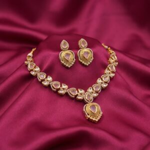 kundan-style teardrop necklace set with engraved gold-tone pendant and matching earrings