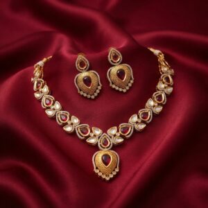 kundan-style teardrop necklace set with engraved gold-tone pendant and matching earrings