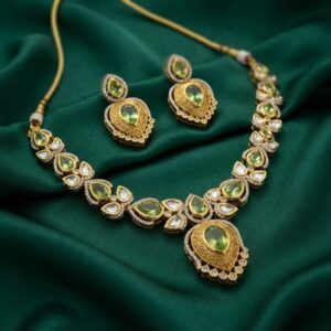 kundan-style teardrop necklace set with engraved gold-tone pendant and matching earrings
