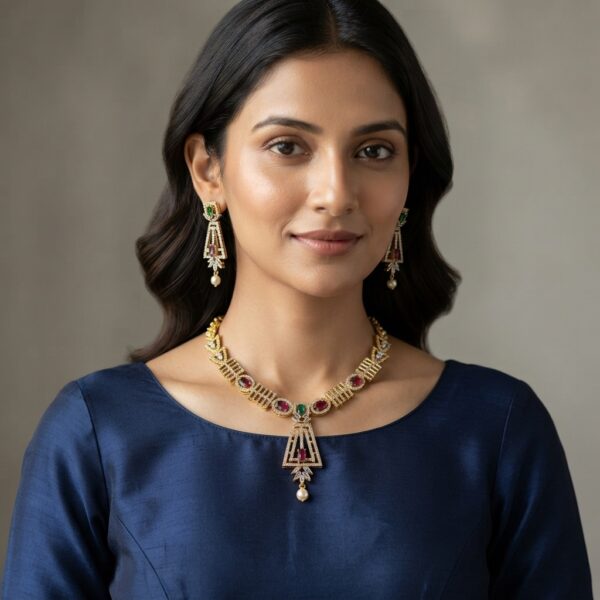 Gold-tone art deco necklace set with cubic zirconia, ruby-coloured stones, faux pearl drop and matching drop earrings