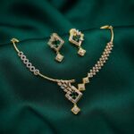 asymmetric necklace set with leaf pendant and matching drop earrings