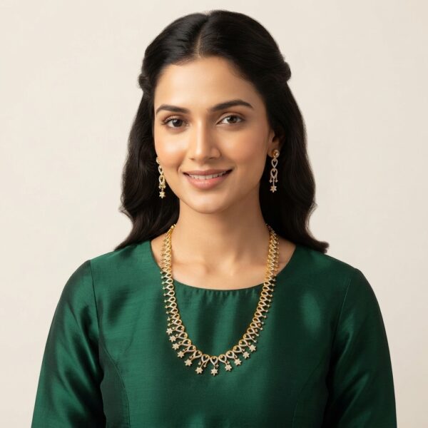 Gold-tone fringe long necklace set with cubic zirconia loop motifs, flower charm drops and matching drop earrings