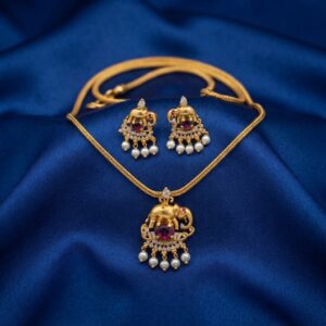 gold-tone elephant pendant necklace set with pearl-style drops and matching earrings
