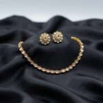 simple gold-tone Indian necklace set with floral stud earrings