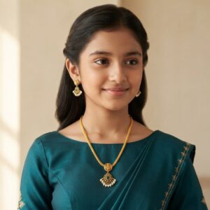 Antique gold-tone South Indian chain necklace set with Lakshmi motif, green stone-style pendant and matching pearl-style drop earrings