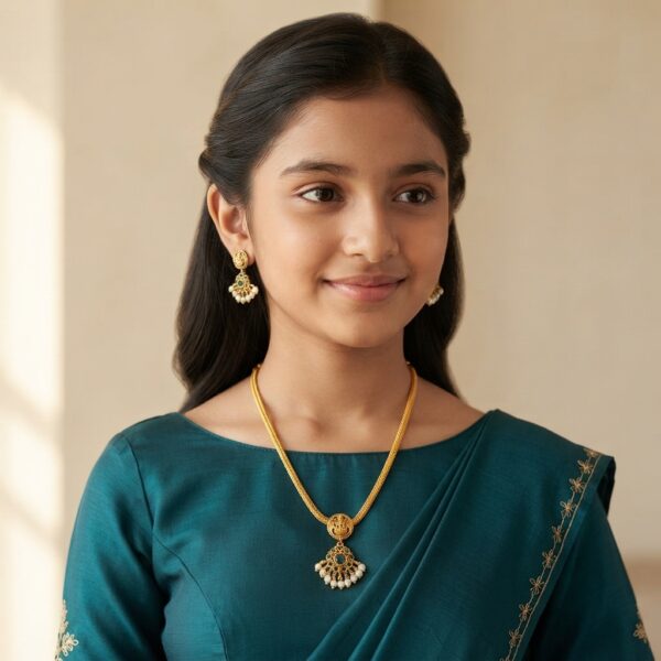 Antique gold-tone South Indian chain necklace set with Lakshmi motif, green stone-style pendant and matching pearl-style drop earrings