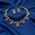 Clear gold-tone floral cluster necklace set with American diamond-style petals and matching drop earrings