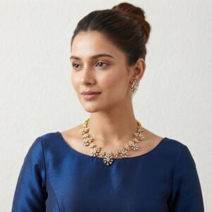 Clear gold-tone floral cluster necklace set with American diamond-style petals and matching drop earrings