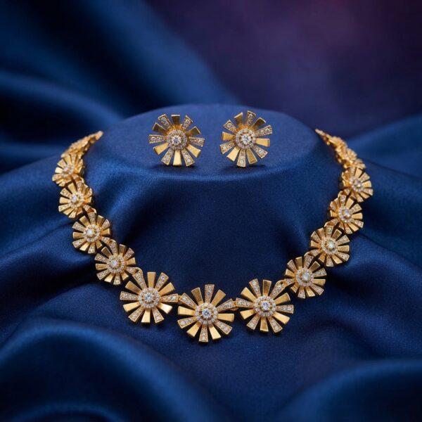 Gold-tone sunburst flower cubic zirconia necklace set with matching stud earrings on navy blue fabric