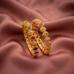 Pair of antique gold-tone Indian bangles with multicolour stone-style accents