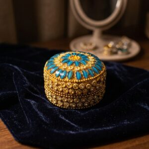 decorative round trinket box with gold-tone beading and stone-style petals