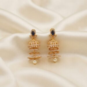 gold-tone American diamond-style jhumka earrings with tiered rings and pearl-style drop