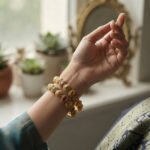 Pair of antique gold-tone Indian bangles with multicolour stone-style accents