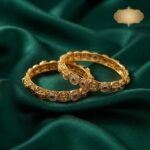 Pair of antique gold-tone Lakshmi coin bangles with temple-style discs and stone-style accents