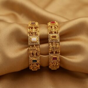 Pair of wide antique gold-tone temple jewellery bangles with figure panels and stone-style