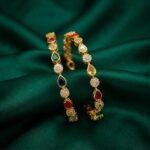 Pair of gold-tone multicolour teardrop bangles with AD-style stone clusters
