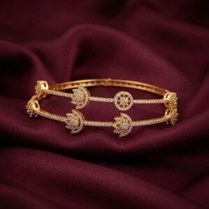 Pair of slim gold-tone American diamond lotus bangles with clear AD-style stones