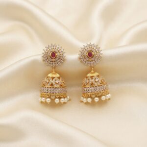 gold-tone sunburst jhumka earrings with AD-style stones and pearl-style drops