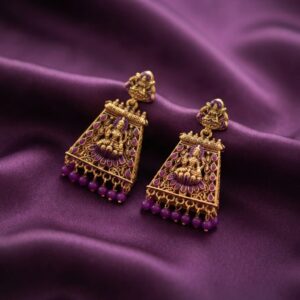 gold-tone temple jewellery earrings with Lakshmi motif and red bead drops