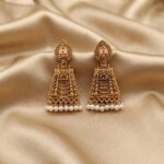 Antique gold-tone gopuram jhumka earrings with pearl-style drops
