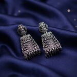 oxidised silver-tone jhumka earrings with Lakshmi motif top and green bead drops
