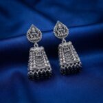 oxidised silver-tone temple jhumka earrings with Lakshmi motif top and maroon bead drops