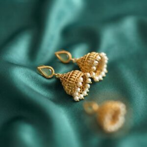 gold-tone filigree jhumka earrings with pearl-style fringe and teardrop stone-style